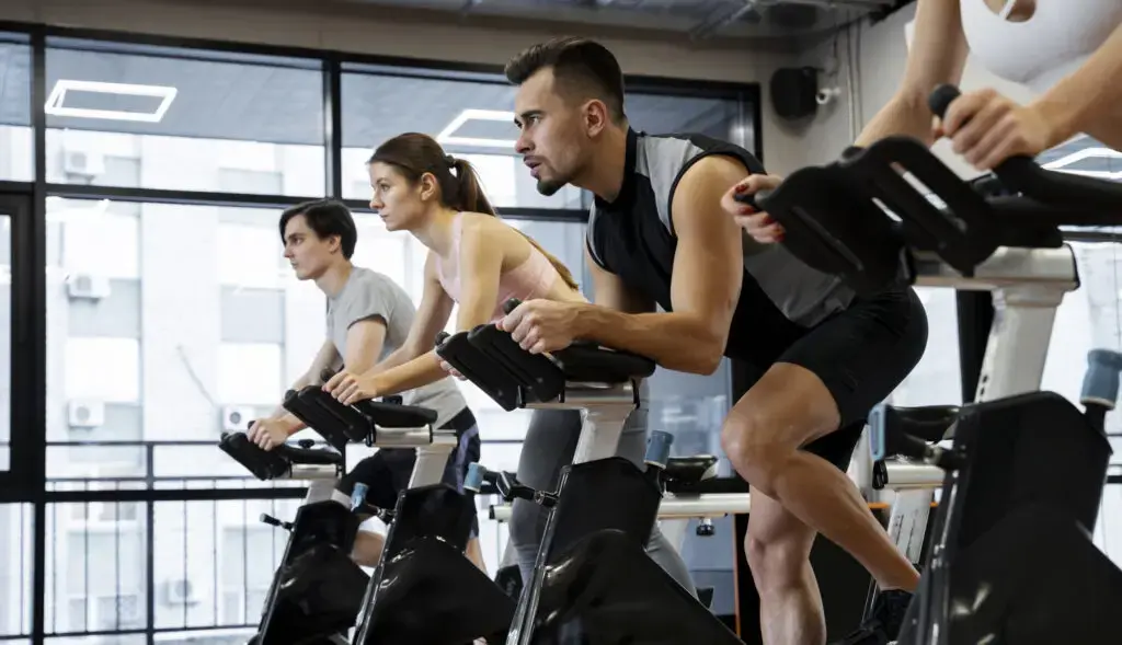 people-doing-indoor-cycling-scaled-e1689558487445-1024x589